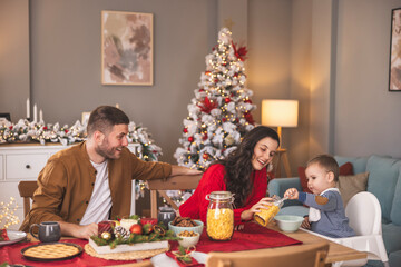 Toddler having cereals for Christmas morning breakfast at home