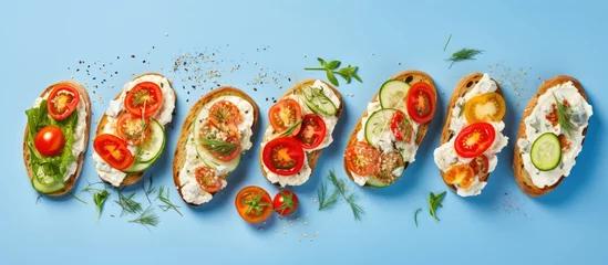 Fotobehang Healthy eating concept variety of open faced sandwiches on rye bread with cream cheese ricotta cherry tomatoes red pepper cucumber slices and dry herbs Copy space image Place for adding text or © Ilgun
