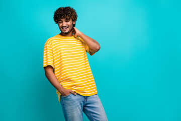 Photo portrait of attractive young man touch neck shopping promo dressed stylish striped yellow clothes isolated on cyan color background
