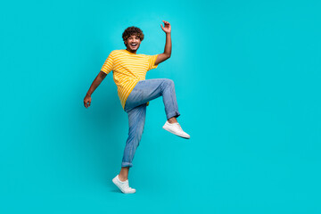 Fototapeta na wymiar Full length profile photo of cheerful overjoyed person good mood big step empty space isolated on teal color background