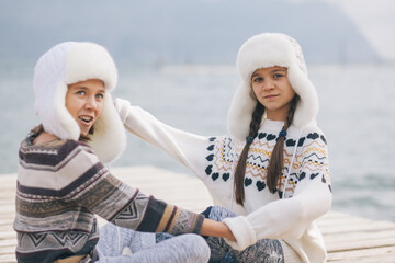 Children travelling in warm wool sweaters and winter hats.