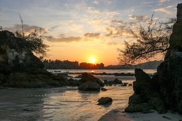 Magnificent colorful sunset in a rocky sea bay.