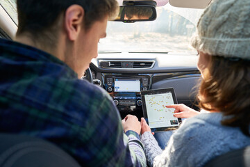 Couple choosing route for road trip