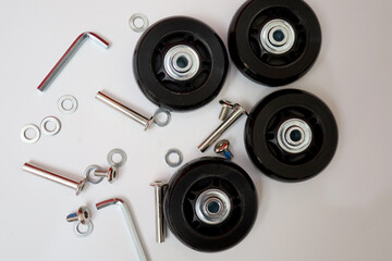 Suitcase wheel spare parts. trolley wheels and bolts as well as washers and keys. replacement of damaged suitcase wheels. - obrazy, fototapety, plakaty