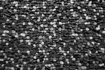 regularly spaced black and white stone wall