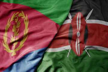 big waving national colorful flag of eritrea and national flag of kenya .