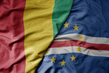 big waving national colorful flag of guinea and national flag of cape verde