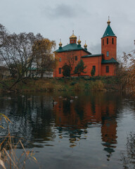 Fototapeta na wymiar Orthodox church in the Dnieper near the water. St. Nicholas Church. Overcast weather. Religion, faith.