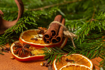 Christmas nature arrangement with dried orange pieces, cinnamon sticks, pine cones, star anise and Christmas tree branches