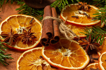 Christmas nature arrangement with dried orange pieces, cinnamon sticks, pine cones, star anise and Christmas tree branches