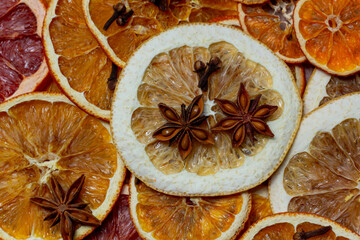 Christmas nature arrangement with dried orange pieces, cinnamon sticks, pine cones, star anise and Christmas tree branches