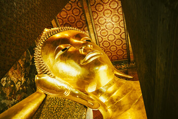 Tranquil Serenity with Reclining Golden Buddha at Bangkok Temple