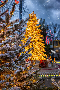 Christmas in Copenhagen, Tivoli Gardens, with a decorated tree, snowfall and bokeh lights, Denmark