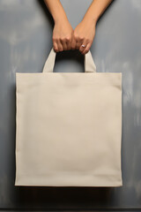 Mock up of pure beige tote bag on grey background