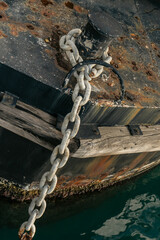 Rusty and anchor chain on mooring bollard
