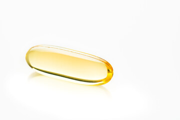 Capsules. Yellow pills isolated on white. Close up capsules with Vitamin D, E or Omega 3,6,9 fatty acids. Food supplement oil filled fish oil. Natural supplements for healthy good life concept. Banner