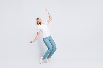Full body photo of careless gorgeous woman wear stylish t-shirt falling look down at empty space isolated on gray color background