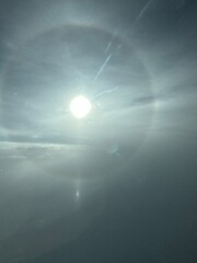 Vertical image of a halo around the sun seen from the sky