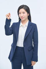 A young businesswoman in a suit is making various facial expressions and gestures.