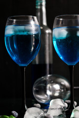 A glass of Blue Lagoon cocktail. on a dark background. a drink