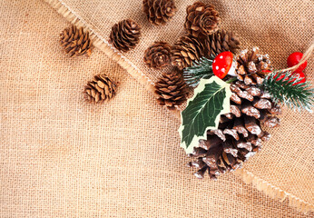 Pinecones on burlap. A simple and rustic Christmas background