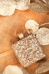 Golden Christmas décor on rustic burlap surface