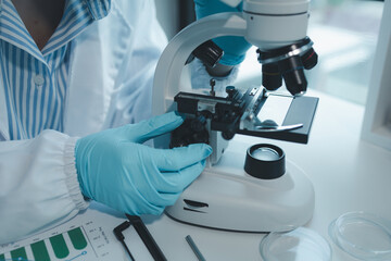 chemist is doing an experiment in the laboratory, A scientist is using a microscope to analyze the chemical composition, A scientific experiment is searching for biological answers in a laboratory,
