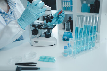 Fototapeta premium chemist is doing an experiment in the laboratory, A scientist is using a microscope to analyze the chemical composition, A scientific experiment is searching for biological answers in a laboratory,