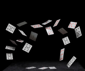 Fototapeta na wymiar playing cards fall on a black table