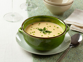 Cream of white asparagus in a green bowl. The rustic style. Selective focus