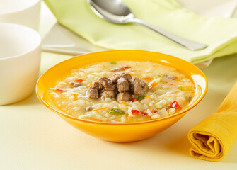 Rice soup with sirloin, tomatoes, carrots, peppers and spices.