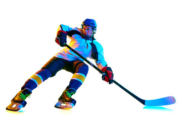Dynamic image of young woman, hockey payer i n motion during game, training, playing against white...