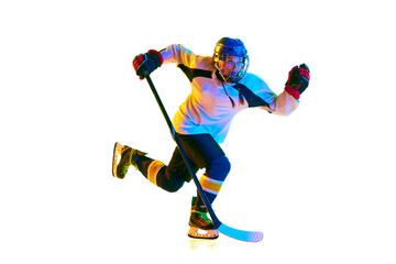 Champion. Young girl, hockey player in motion, wearing uniform, playing with stick against white background in neon light. Concept of professional sport, competition, game, action, hobby