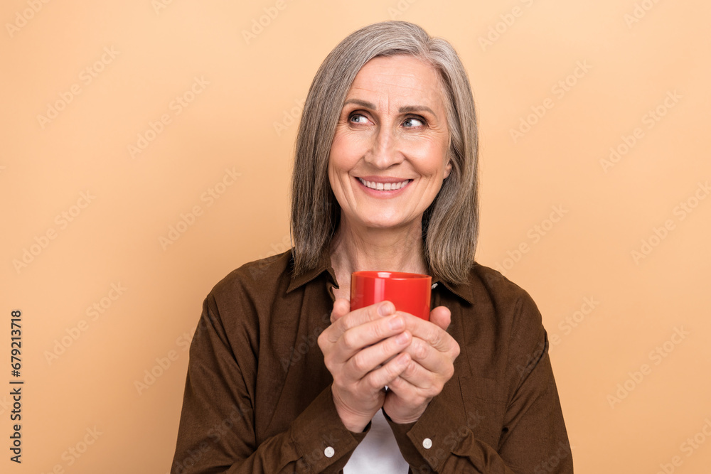 Sticker photo of satisfied retired woman drink latte wear brown casual shirt business lady dreamy look novel