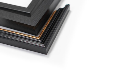 A pile of empty picture frames and mouldings on a clean white background