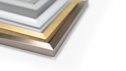 A pile of empty picture frames and mouldings on a clean white background