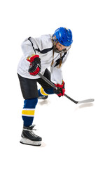 Obraz premium Young girl, hockey playing in helmet, uniform, with stick training, playing isolated over white background. Concept of professional sport, competition, game, action, hobby, achievements