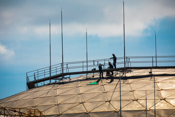 Male workers rope access height safety connecting with eight knots safety harness, clipping into...