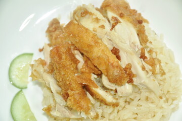 steamed rice topping chop crispy fried  chicken on plate with chili sauce and soup