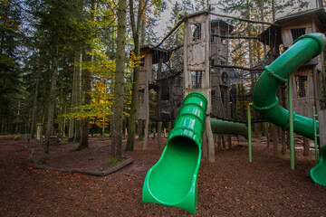 Playground in the woods at Bad Wildbad, Black Forest, Germany, wooden construction for climbing with plastic slide