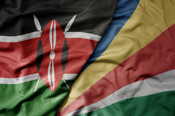 big waving national colorful flag of kenya and national flag of seychelles .