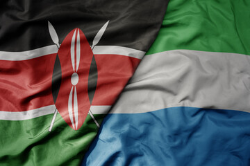 big waving national colorful flag of kenya and national flag of sierra leone .