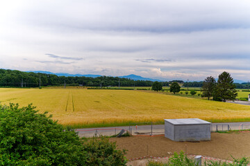 Fototapeta premium Scenic agriculture landscape at Swiss highway service station Rose de la Broye on a cloudy late spring day. Photo taken June 11th, 2023, Lully, Switzerland.