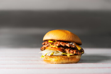 Burger lies on the table in the kitchen 