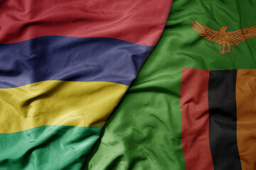 big waving national colorful flag of mauritius and national flag of zambia .