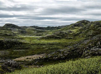 Landscape of green polar rocky tundra. Northern nature of Teriberka