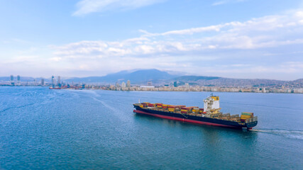 container carrying ship passes through the gulf of izmir