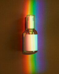 A cosmetic bottle with a rainbow.view from above