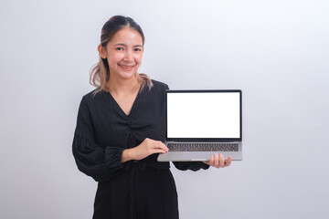 Portrait of young happy business woman holding white screen laptop. Attractive female in smart casual wear holding a computer and present her job or work. Digital tachnology communication concept.