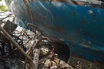 Abandoned Derelict Blue Boat on Florida Shoreline. Sunny Day in mangroves